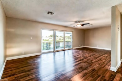 Spare room with ceiling fan and dark hardwood / wo