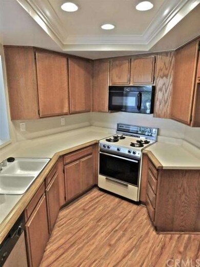 The kitchen features gas appliances and recessed l