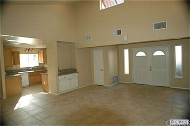 View of spacious living room with high ceilings, t