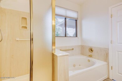 Master bathroom with shower and soaking