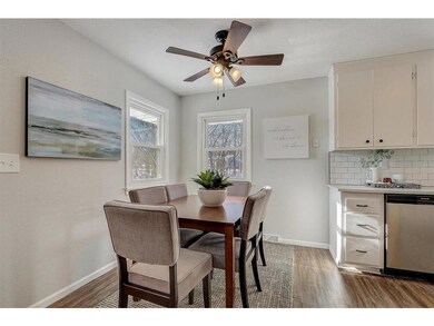 Open dining and kitchen are filled with natural li