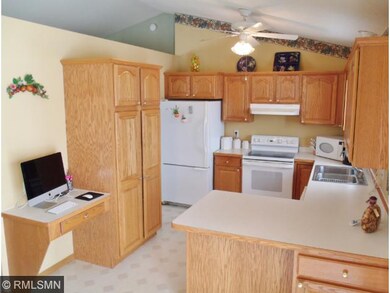 Kitchen features the warmth of oak cabinetry and o