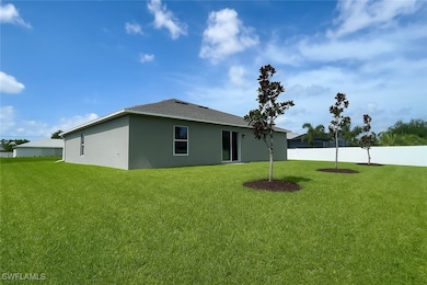 Rear view of house with stucco siding