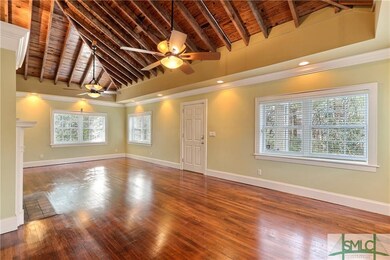 View of the front door. Exposed wood beam tresses 