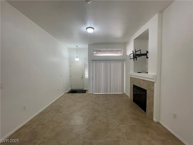 Unfurnished living room with a tile fireplace and