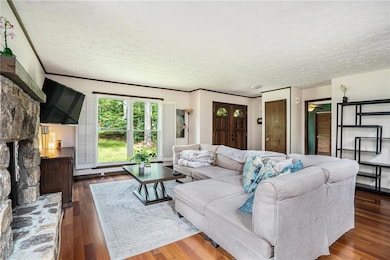 Living area with a textured ceiling and wood finished floors