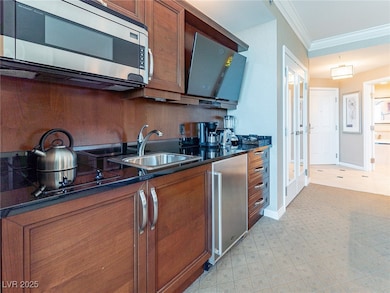 Kitchen with dark countertops, ornamental molding,