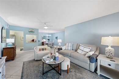 Living room featuring baseboards, a textured ceili