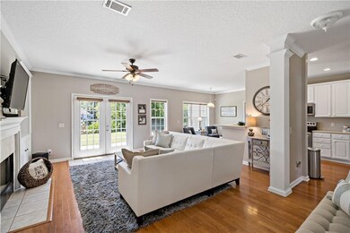 Living room offers fireplace, hardwood floors and