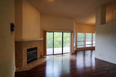 Unfurnished living room featuring a tile fireplac