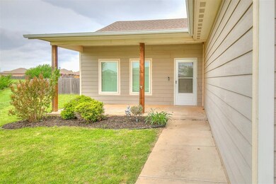 Property entrance featuring fence and a lawn