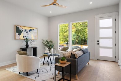 Living room featuring light wood-style flooring, recessed lighting, and a ceiling fan