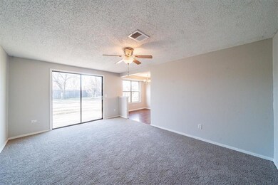 Carpeted empty room featuring ceiling fan with not