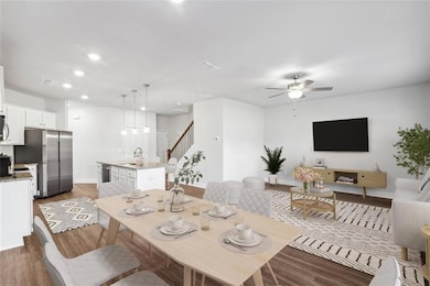 Dining room with ceiling fan, sink, and dark wood-