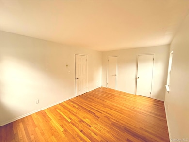 Bedroom with Hardwood Floors and Two Closets