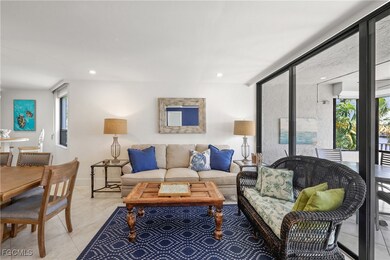 Living room with light tile patterned floors and recessed lighting