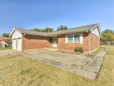 Ranch-style home with brick siding, a shingled roof, and driveway