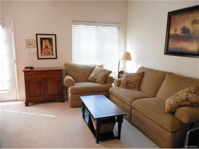 The sunken living room is bright and sunny...
