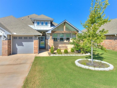View of front of property with a shingled roof, a front lawn, brick siding, concrete driveway, and an attached garage