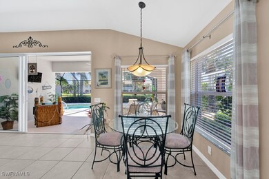 Dining space with vaulted ceiling and light tile p