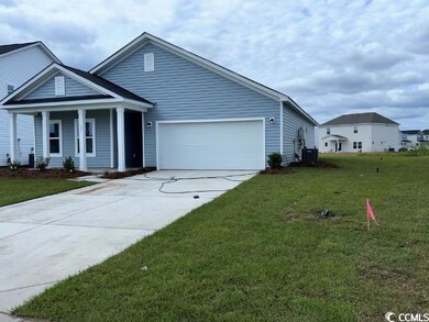 View of front of home with a garage, a porch, cent