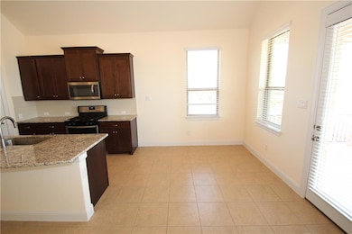Kitchen with appliances with stainless steel fini