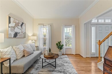 Living area with crown molding and light wood-type