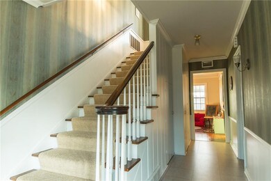 Grand staircase.  Half bath to the right, storage 