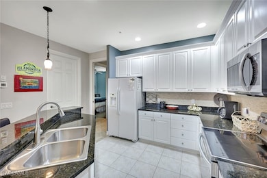 Kitchen with stainless steel appliances, a sink, h