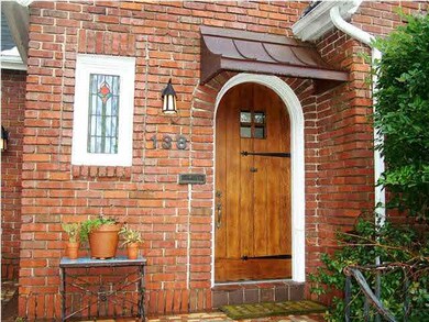 Welcoming entry with copper roof, front porch and 