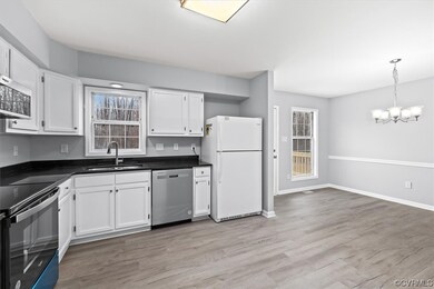 Kitchen featuring white cabinets, appliances with