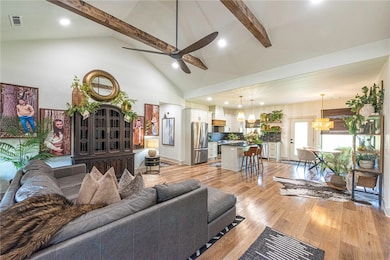 Open Concept living with vaulted ceilings and wood