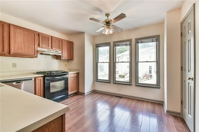 Kitchen featuring brown cabinetry, stainless steel