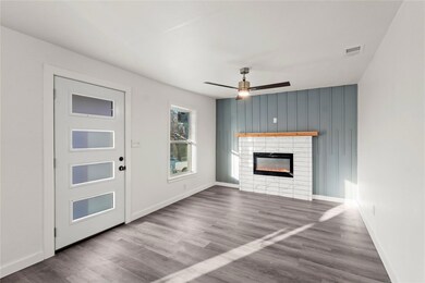 Unfurnished living room with a tiled fireplace, ha