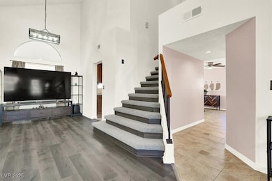 Stairway featuring a towering ceiling and elegant design carpet-planks combination.