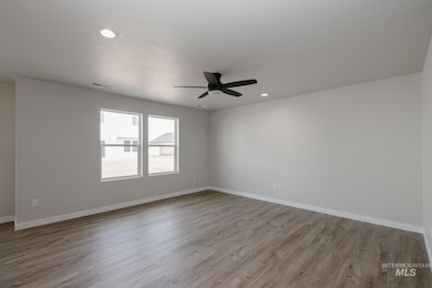 Unfurnished room with light wood-style floors, recessed lighting, and a ceiling fan