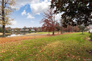 View of home's community featuring a lawn and a wa