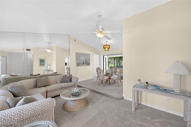 Living area featuring a ceiling fan, carpet floors