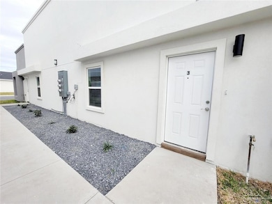 Property entrance featuring stucco siding