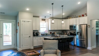 Kitchen with visible vents, dark wood-type floorin