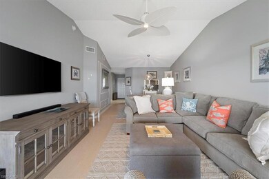 Living room featuring ceiling fan, light wood-type