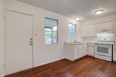 Kitchen with white range with electric stovetop, 