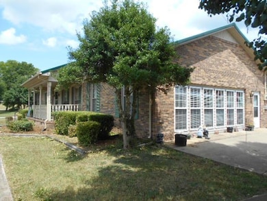 Side view of the main home. Two-car garage and car