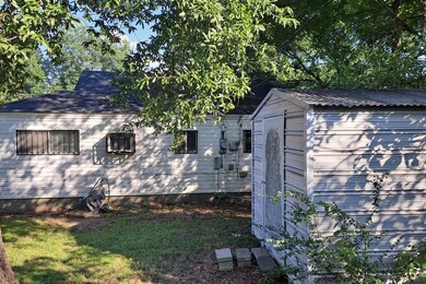 View of home's exterior with a shed and a yard