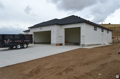 View of side of home with driveway and an attached garage