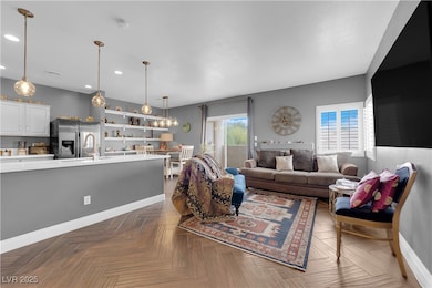 Living area with baseboards and recessed lighting