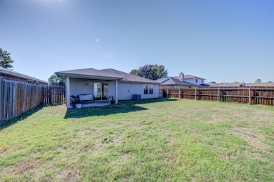 Rear view of property featuring a patio, a ceiling fan, a fenced backyard, and a shingled roof