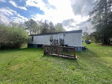 Back of house with a yard