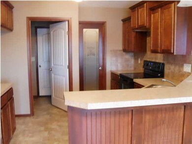 Raised breakfast bar overlooks dining/deck and lak