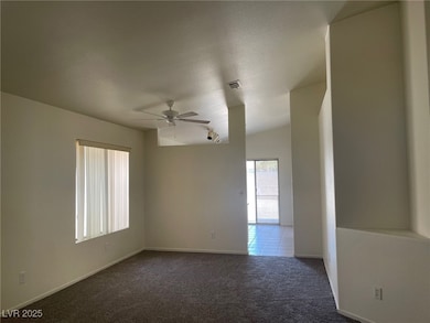 Spare room with ceiling fan, carpet flooring, and